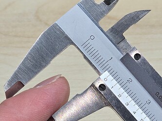 Figure 3: Author's finger as compared to a 14 mm gauge.