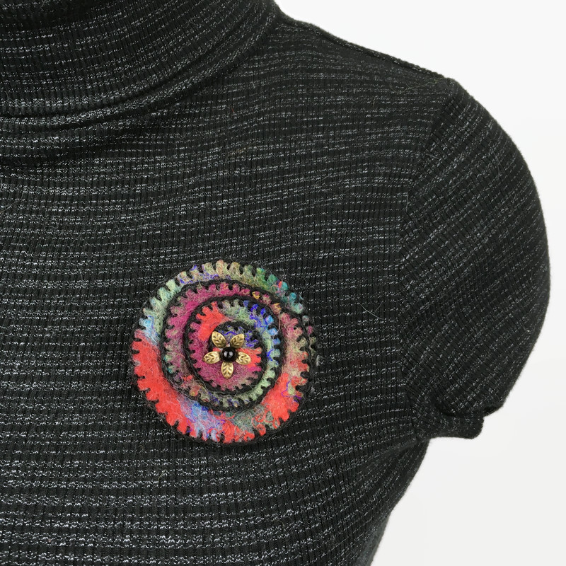 7437631-Multicoloured-spiral-felt-brooch-with-black-stitching-reduced-by-50--0