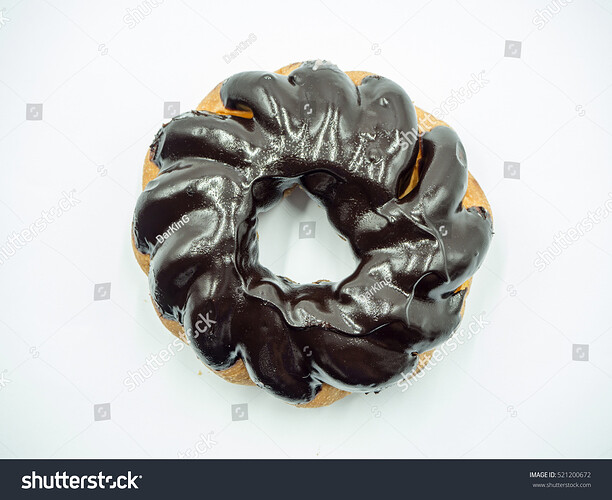 stock-photo-black-spiral-donut-on-white-background-top-view-521200672